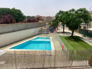an empty swimming pool with a fence around it at Casa rural El Yelmo in Miguel Esteban