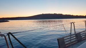 a boat on a body of water at sunset at Catamaran Jaso in Jadranovo