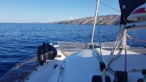 a boat in the middle of a body of water at Catamaran Jaso in Jadranovo +1 photo