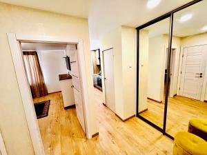 a living room with a door and a mirror at M&M Apartment VI SELF CHECK-IN in Panevėžys