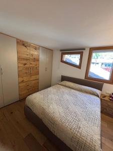 Ένα ή περισσότερα κρεβάτια σε δωμάτιο στο Pragma Apartments - Wood Lodge Predazzo