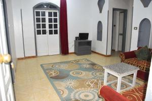a living room with a couch and a table at Pauline Guest House in Luxor