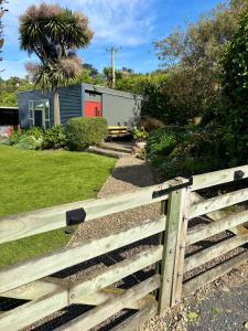 a wooden fence in front of a house at Brighton Beach in Dunedin