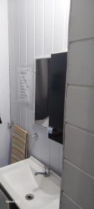 a bathroom with a white sink and a mirror at Recanto do pepe in Chuí +5 photos