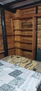 a bed in a room with wooden walls at Recanto do pepe in Chuí