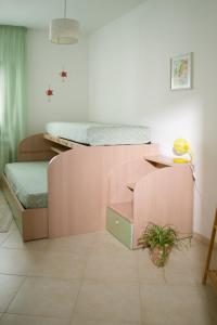 a room with two bunk beds and a table and a plant at Casa Vacanza la Civetta in Castri di Lecce