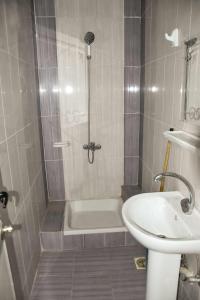a bathroom with a shower and a sink and a tub at Pauline Guest House in Luxor +44 photos