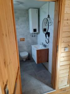 a bathroom with a sink and a toilet at Osada Międzywodzie in Międzywodzie +84 photos