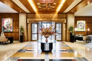a lobby with a table with a vase of flowers on it at Mandarin Oriental, Boston in Boston