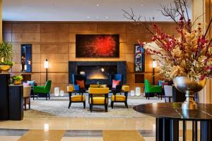 a lobby with a fireplace and tables and chairs at Mandarin Oriental, Boston in Boston