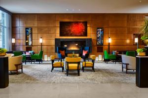 a lobby with tables and chairs and a fireplace at Mandarin Oriental, Boston in Boston
