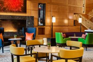 a lobby with tables and chairs and a fireplace at Mandarin Oriental, Boston in Boston