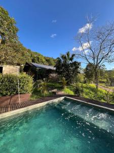 a swimming pool in front of a house at Pool amid the green in Gaspar