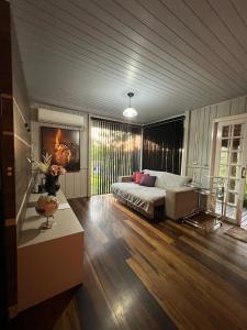 a large living room with a bed and a table at Pool amid the green in Gaspar
