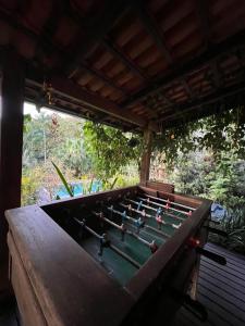 a large pool table with people on top of it at Pool amid the green in Gaspar