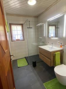 a bathroom with a sink and a shower at Apartments Sarazena in Saas-Grund +11 photos
