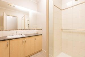 a bathroom with a sink and a shower at Mildura City Centre Escape 2 in Mildura +13 photos