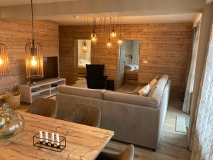 a living room with a couch and a table at Apartments Panorama Donovaly in Donovaly