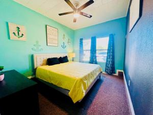 a bedroom with a bed and a ceiling fan at Yellow Texas Star House blocks from Goodfellow AFB in San Angelo