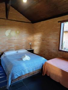 Postel nebo postele na pokoji v ubytování Chalés Itaoka Belvedere