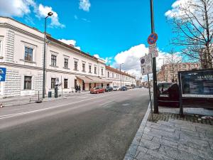 an empty city street with cars parked on the road at Moonlight City Center Studio Private Parking in Cluj-Napoca