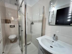 a bathroom with a shower and a sink and a toilet at Moonlight City Center Studio Private Parking in Cluj-Napoca +18 photos