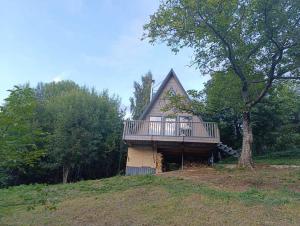 a house with a deck on top of a hill at М'юзіка Карпат in Yavoriv