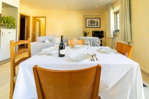 een tafel met een fles wijn erop bij Gouveia Forest Guest House in Gouveia