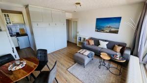 a living room with a couch and a table at LUV & LEE Waterkant SPO in Sankt Peter-Ording