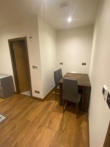 a dining room with a table and chairs in a room at Newly Furnished, Ensuite Room with a Private Entrance in Colindale