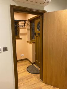 a hallway with a door leading to a room at Newly Furnished, Ensuite Room with a Private Entrance in Colindale