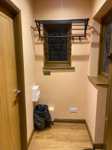 a hallway with a window and a trash can at Newly Furnished, Ensuite Room with a Private Entrance in Colindale