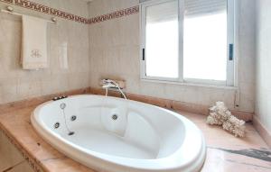 a large white tub in a bathroom with a window at Casa Traiguera in Traiguera +19 photos