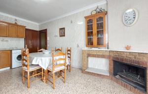 a kitchen with a table and chairs and a fireplace at Casa Traiguera in Traiguera