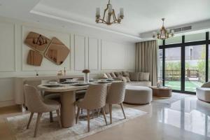 a living room with a table and chairs and a couch at Luxury Apartments in Cairo Festival City in Cairo