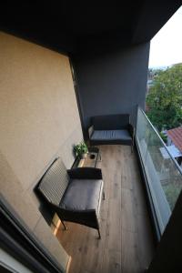 an overhead view of a balcony with a couch and chairs at Cristal Palace Suites 004 in Kragujevac