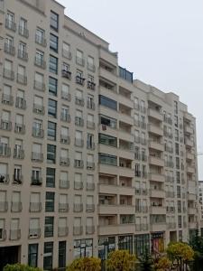 an apartment building with balconies on the side of it at Pristhine Stay Inn 20 in Prishtinë