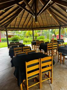 a group of tables and chairs under a pavilion at Hotel Fazenda Haras RD in Olímpia