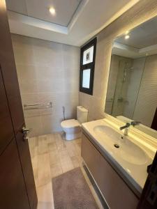 a bathroom with a sink and a toilet and a mirror at Luxury Apartments in Cairo Festival City in Cairo +51 photos