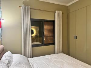 a bedroom with a bed and a window at 603 Apartments in Baddah +11 photos