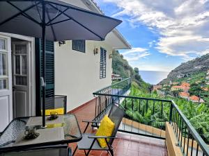 リベイラ・ブラーヴァにあるBanana Loversのバルコニー(テーブル、傘付)