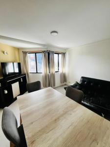 a living room with a wooden table and a couch at Downtown rental in Río Grande +2 photos