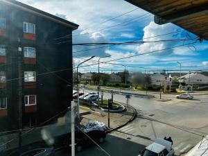 a view of a parking lot with cars and a building at Downtown rental in Río Grande
