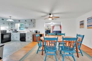 a kitchen and dining room with a table and chairs at Park your Boat! Mins from the Ocean•Screened Porch in Harkers Island