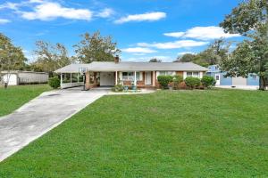 a home with a driveway and grass at Park your Boat! Mins from the Ocean•Screened Porch in Harkers Island