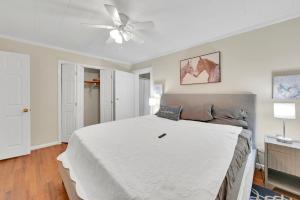 a bedroom with a bed and a ceiling fan at Park your Boat! Mins from the Ocean•Screened Porch in Harkers Island