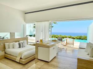 a bedroom with a bed and a view of the ocean at Encanto Acapulco in Acapulco