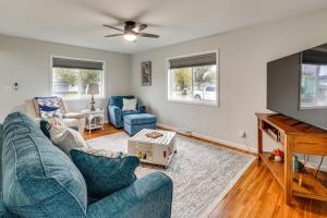 a living room with a blue couch and a tv at Walk to Lagoon Saloon! Chic Home on Nugents Canal in Lacarne