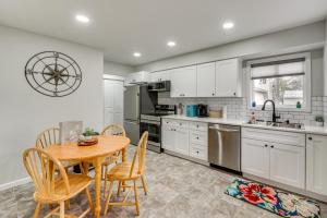 a kitchen with white cabinets and a table and chairs at Walk to Lagoon Saloon! Chic Home on Nugents Canal in Lacarne