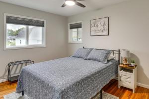 a bedroom with a bed and two windows at Walk to Lagoon Saloon! Chic Home on Nugents Canal in Lacarne